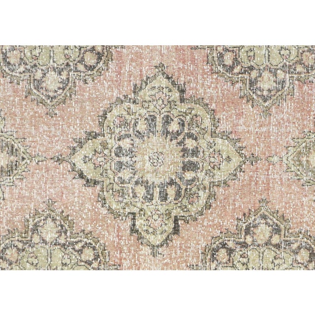 A vintage Turkish Oushak measuring 4'4" x 11'10", hand-woven with wool on wool foundation. This piece displays the...