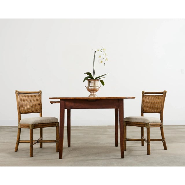 Charming 19th century country English provincial farmhouse dining table crafted from fruitwood. The round table features a...