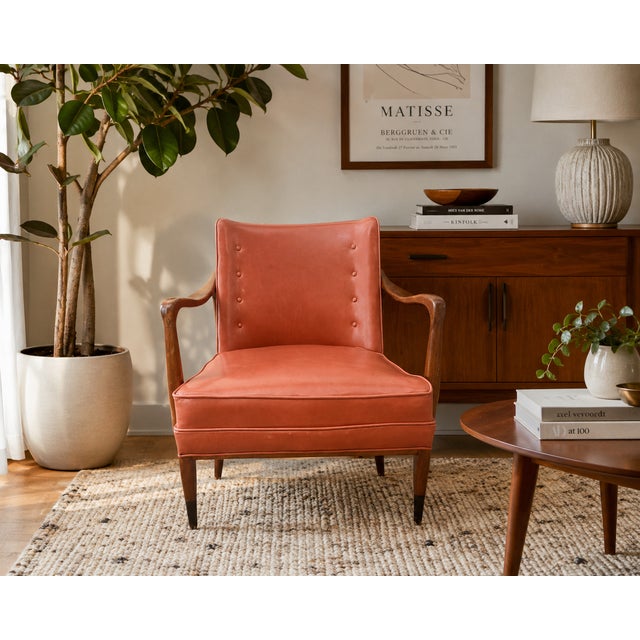 An elegant vintage mid-century modern lounge chair featuring a sculptural exposed wood frame, beautifully tufted original...