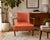 An elegant vintage mid-century modern lounge chair featuring a sculptural exposed wood frame, beautifully tufted original...