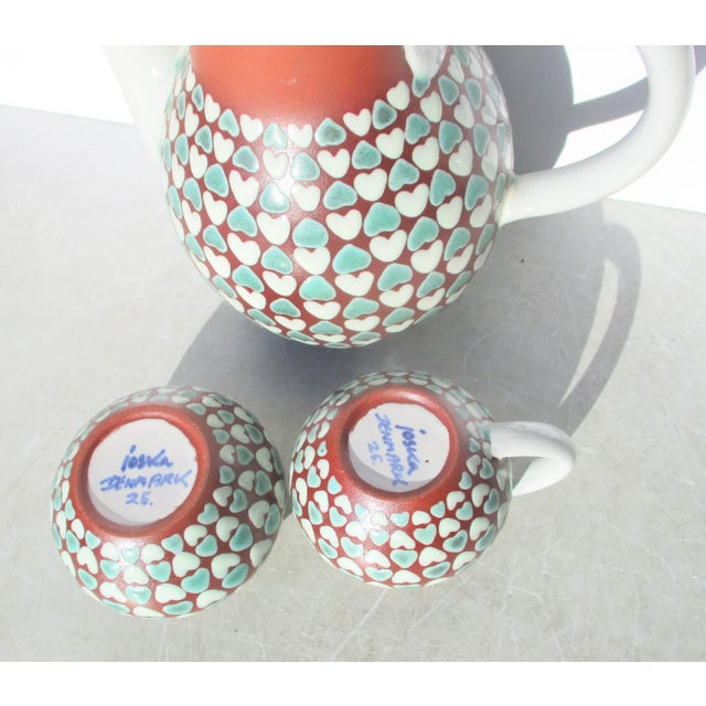 Tea service by Ioska. Designed with a red ware body and patterned hearts in white and green. Milky white glaze over the...