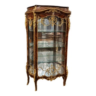 Ornate French Louis XV Curio Cabinet – Glass Shelving, Gilded Accents & Graceful Bombe Design For Sale