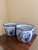 A classic pairing of blue and white porcelain planters, rendered in a softly faceted, scalloped form that feels both...