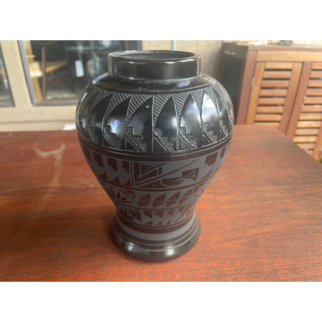 Yes, this is a stunning example of black-on-black etched pottery handcrafted by renowned Diné (Navajo) artist Marvin...