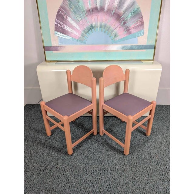 Stunning postmodern pair of Padova dining chairs by Hank Lowenstein. They feature lacquered pink frames with clean purple...