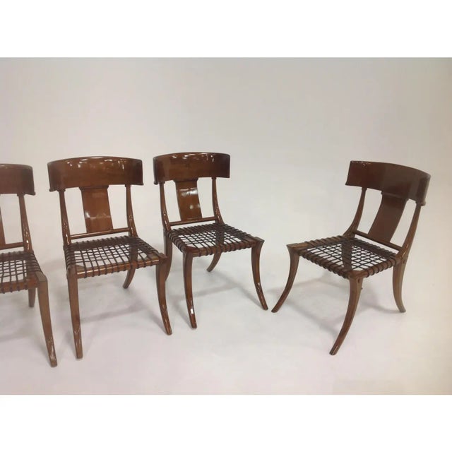 A set of 6 Modern dining chairs. The chairs are in the manner of Robsjohn Gibbings. The Klismos style dining chairs are...