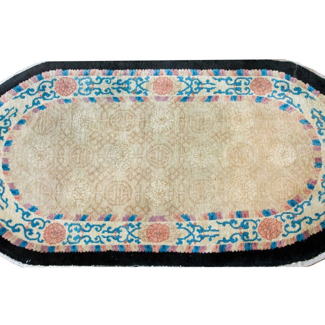 A wonderful early 20th century Chinese Peking oval rug with a central field woven with a subtle tone on tone Shou...