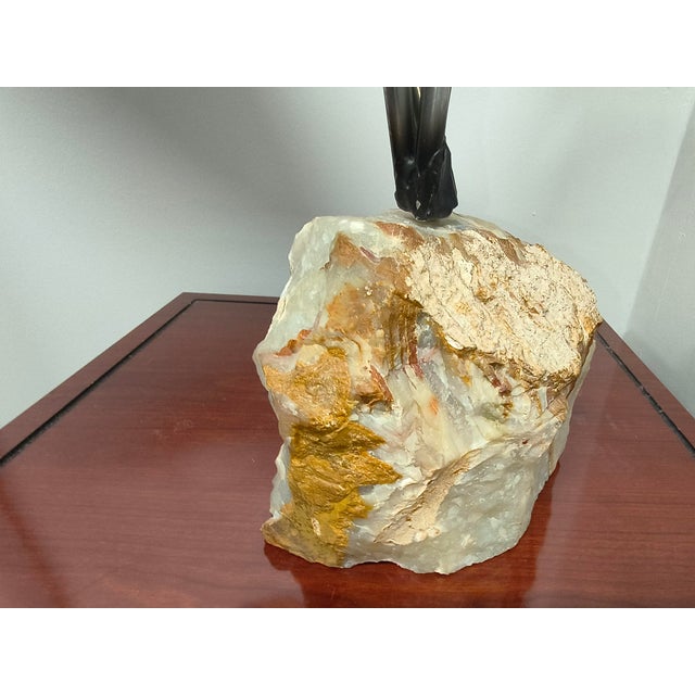 sculpture of sweeping chrome leaves and alabaster bird set on rugged stone block. 23" at widest point. 18" tall