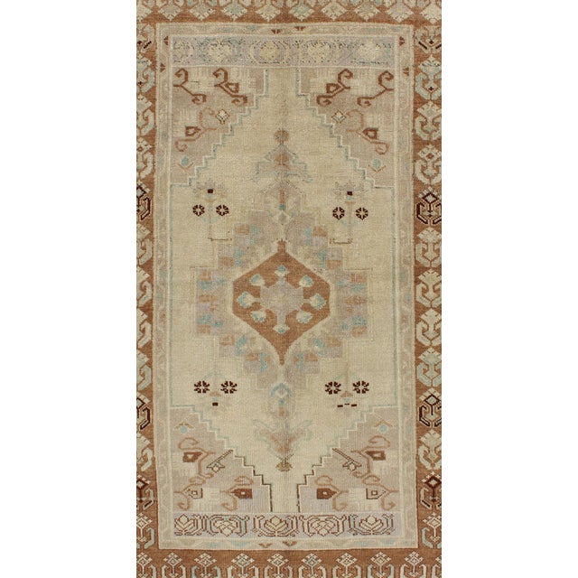 Measures: 3'4 x 6'2 Vintage Turkish Oushak Rug with Soft Beige, Muted Blue, and Warm Brown 3'4 x 6'2. Keivan Woven Arts /...