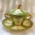 This is a green and cream two handle Dresden teacup or dessert cup. It comes with a matching lid and underplate or saucer....