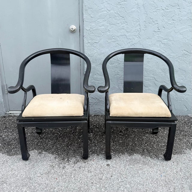 Dramatic pair of vintage James Mont-style horseshoe armchairs inspired by traditional Chinese furniture forms. Each chair...