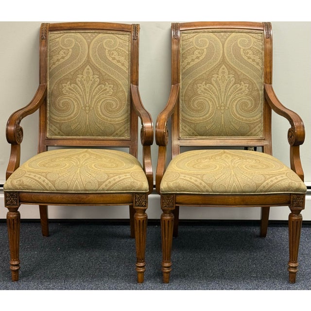 Elegant set of six Ethan Allen dining chairs, including four side chairs and two armchairs. Each chair features a warm...