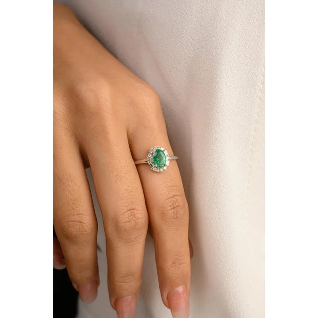 This is part of Chairish’s Fine Jewelry assortment. Art Deco Style Emerald Engagement Ring with Halo Diamonds in 14K Gold...