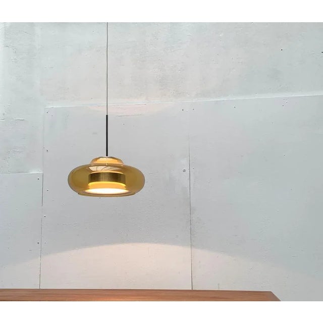 Impressive glass pendant lamp from the renowned manufacturer Doria Leuchten. A game with transparency and form. The...