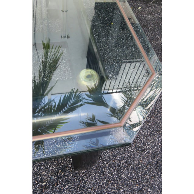 This beautiful Mid-Century Coffee Table is made out of wood, and glass. This Coffee Table has a classic Hollywood Regency...