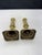 Pair of vintage Brass candlesticks featuring a turned design with square bases. Condition shows wear, including some...