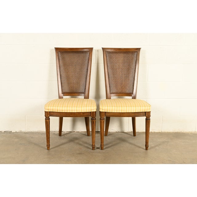A gorgeous pair of French Regency Louis XVI style side chairs or dining chairs By Henredon USA, Circa 1970s Carved solid...