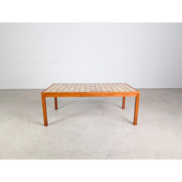 Beautiful rectangular vintage coffee table from the 1970s for sale. The table features a typical Brutalist tiled top and...