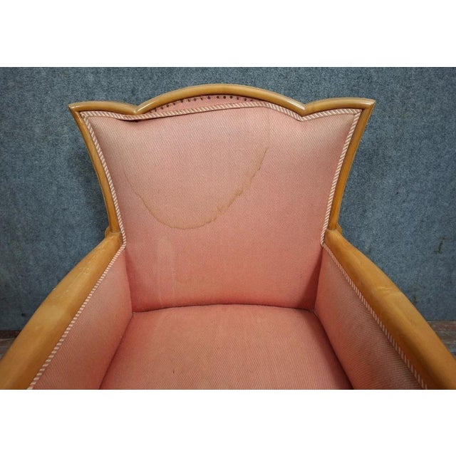 Charming Art Deco armchair in light, molded wood, resting on slightly curved legs at the front and saber legs at the back,...