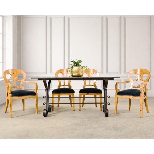 A beautifully crafted set of twelve opulent maple burlwood veneer dining chairs made in the Viennese Biedermeier taste....