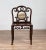 An antique Chinese rosewood side chair from the early 20th century, with marble medallion inlay and open fretwork. Born in...