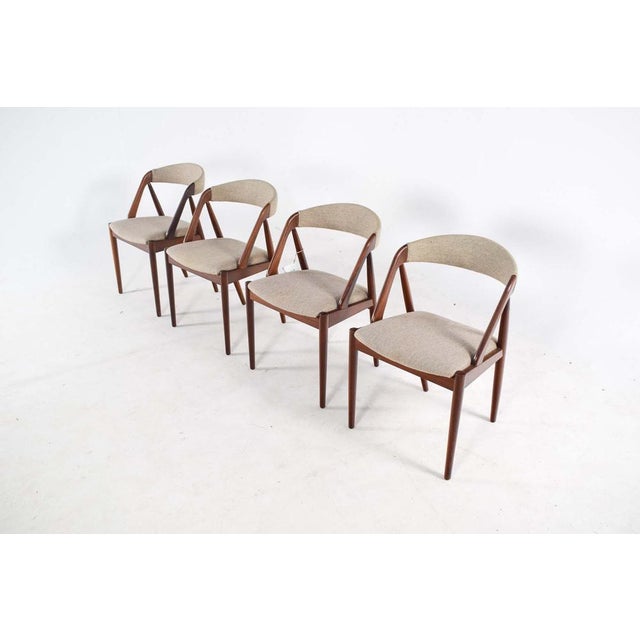 Set of four teak dining chairs by Kai Kristiansen. Model 31. These Danish Mid-Century dining chairs were designed by Kai...