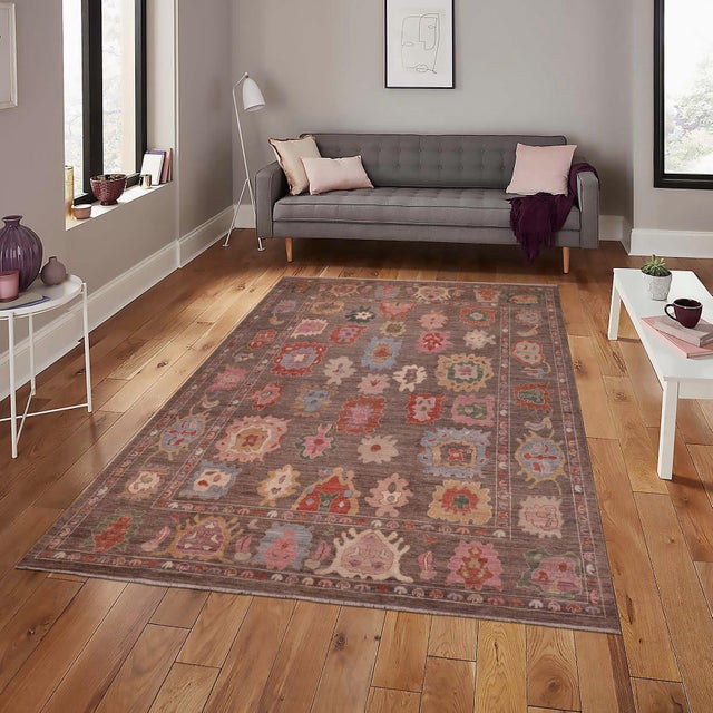 Enhance the ambiance of your home with this magnificent Persian-influenced Turkish hand-knotted rug made by skilled...