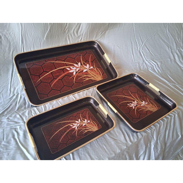 Gorgeous set of 3 Asian style serving trays with an iris theme decor. This set has a black lacquerware look with the...