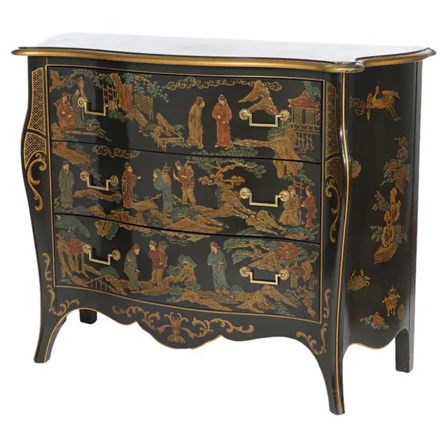 A Chinoiserie decorated commode by Drexel Heritage offers ebonized swell front case with shaped top over three drawers,...