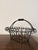 This is a vintage French-style black wire and wrought iron gathering basket with a scalloped rim and a twisted wire handle