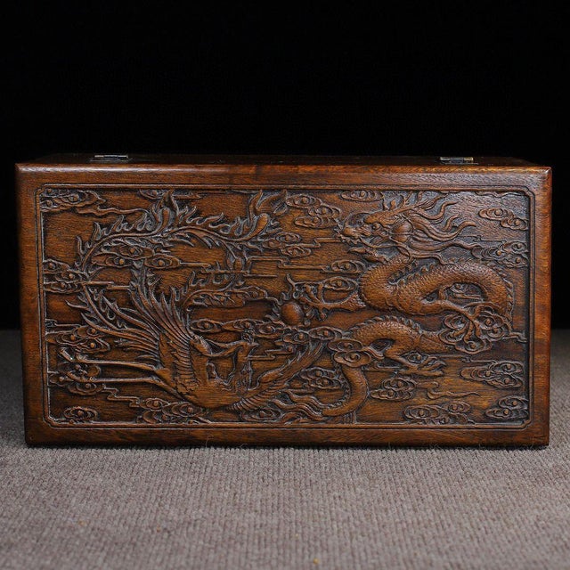 A magnificent vintage Chinese storage box, handcrafted from solid Huali wood (rosewood). This substantial piece features...