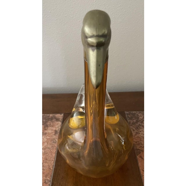 An elegant figural decanter or claret jug in the form of a stylized swan, characteristic of the the 1930s-1940s Art Deco...