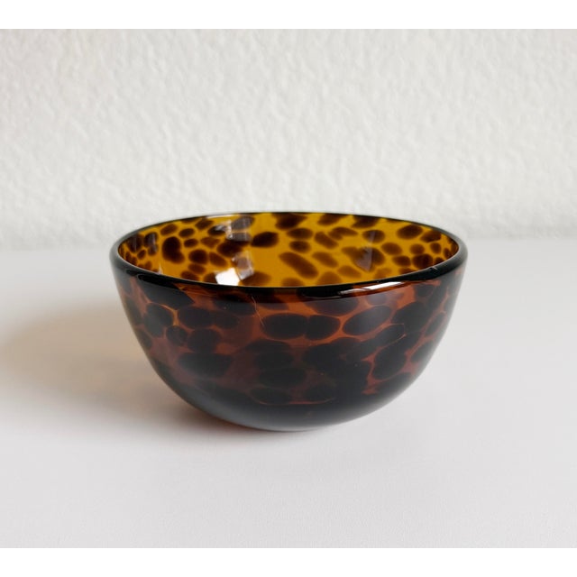 Versatile blown glass bowl produced by Ralph Lauren. Features a deep brown tortoise pattern with a warm mid-tone body...