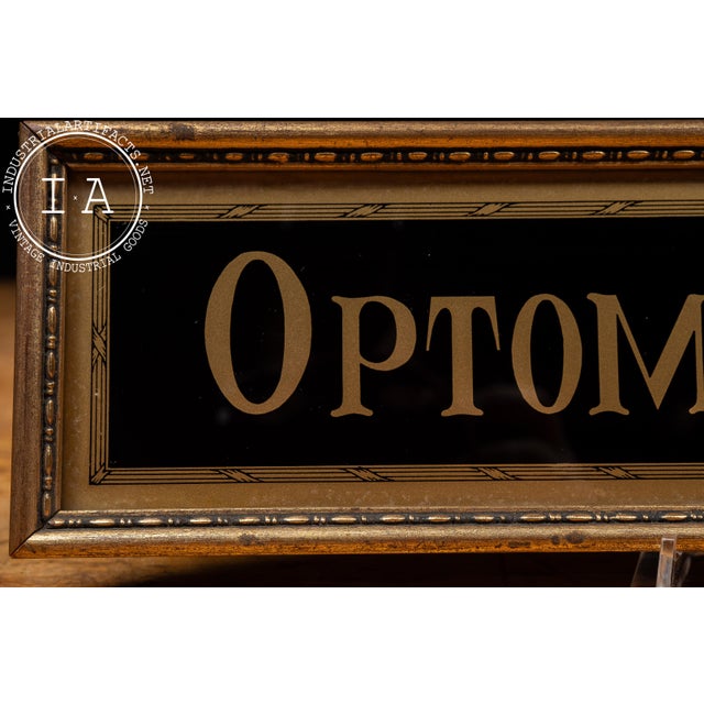 Reverse-painted glass "Optometrists" advertising sign from the Tallimit Art line produced by C. & A. Richards of Boston,...