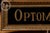 Reverse-painted glass "Optometrists" advertising sign from the Tallimit Art line produced by C. & A. Richards of Boston,...