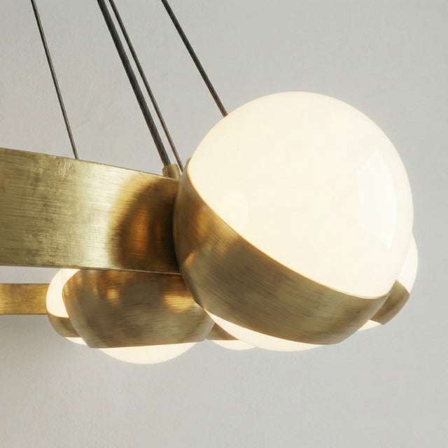 This lamp is an elegant and striking piece of contemporary design with Mid-Century inspiration. It features a circular...