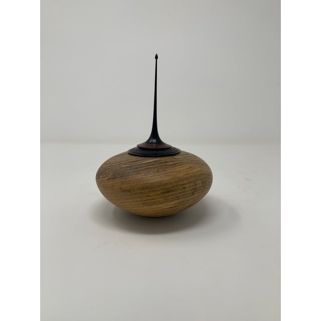 Unique wooden jar with pointed lid.