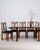 This set of dining chairs with table makes its impression through dark wood, black upholstered seats. The piece dates to...