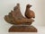 Vintage MCM bird perched on a piece of driftwood. The bird as well as the driftwood pivots on a brass rod so the bird can...