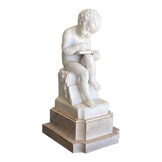 Early 20th Century Italian Porcelain Bisque Figure of a Putto Writing After Canova For Sale