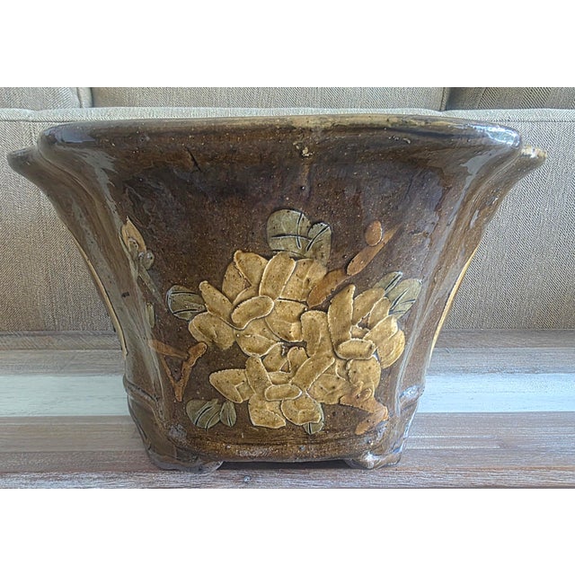 A stunning decorative glazed stoneware planter with a crane and floral design influences. As you can see, this piece makes...