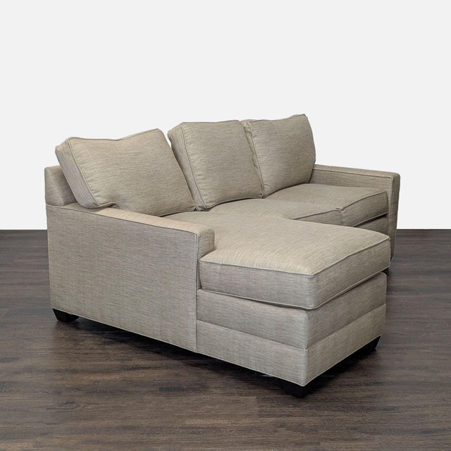 This Ethan Allen sectional offers spacious seating with a modern design. It features a left-facing chaise, clean lines,...