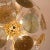Sputnik style chandelier with Murano glass discs in golden tones and with different textures and reliefs. An exquisite...