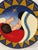 Lovely redware decorative plate featuring a vibrant hand-painted motif of Madonna and child. Loop on back should desire to...