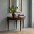 Mahogany half-lune console table. Folding top supported by a central rear leg, with a pull-out drawer. Internal top in...