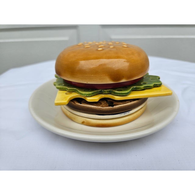 A ceramic Mid-Century Modern hamburger coaster set attributed to Jo Anne Marquardt for Jam. Inc. The actual set consists...