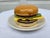 A ceramic Mid-Century Modern hamburger coaster set attributed to Jo Anne Marquardt for Jam. Inc. The actual set consists...