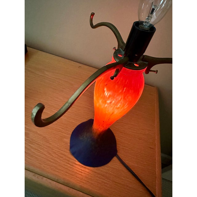 This striking decorative table lamp has a molded glass base reminiscent of Art Deco styling. The coloration is a deep blue...