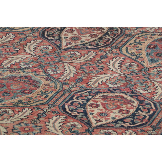 Made with hand-knotted wool circa 1910-1920, this 12x15 antique Persian rug is a rich and rare collectible of Kerman Lavar...