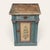 European folk-painted cabinet featuring a drawer above a cupboard door, retaining its original blue-green painted finish,...